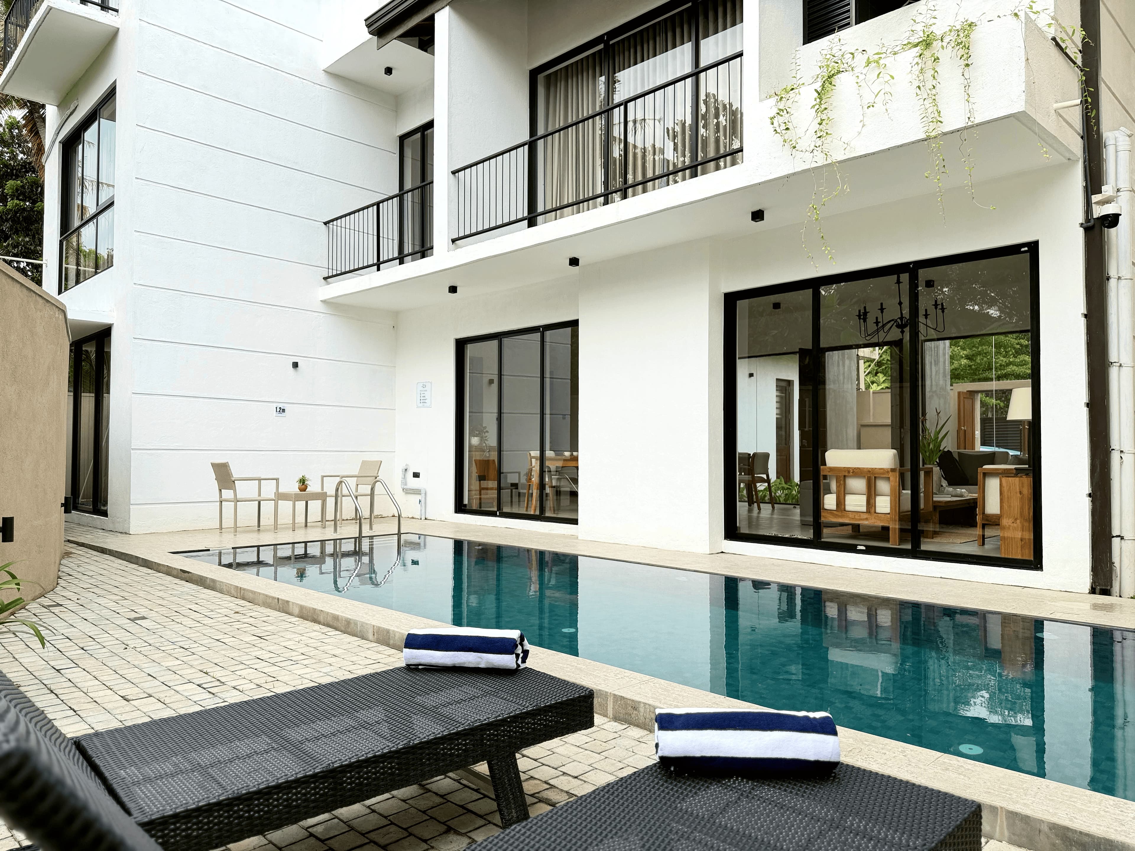 Interior detail with swimming pool beyond at Ayu by TARA